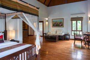 a bedroom with a bed and a living room at Royal Lanta Resort & Spa in Ko Lanta