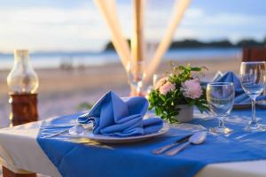 a table with a blue table cloth and a plate of food at Royal Lanta Resort & Spa in Ko Lanta
