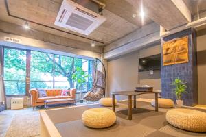 a living room with a couch and a table at AMP FLAT Nishijin 2 in Fukuoka