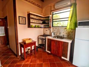 a small kitchen with a sink and a refrigerator at Sunny Palm Villas in Laborie