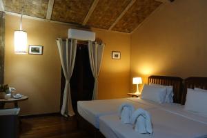 Postel nebo postele na pokoji v ubytování Sala Done Khone Hotel