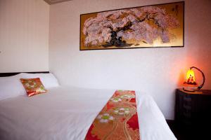 Tempat tidur dalam kamar di Yamagata KYOMACHI HATAGO KITAYAMAOMIYA