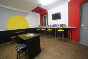 a room with a bar with stools and a tv at Cool Traveler in Kyiv