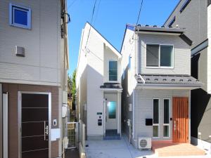 an alley between two buildings with a house at COTO Tokyo Shibuya 7 in Tokyo