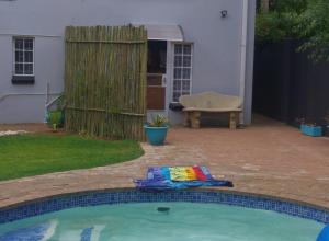 a swimming pool in the backyard of a house at Triginta in Bloemfontein