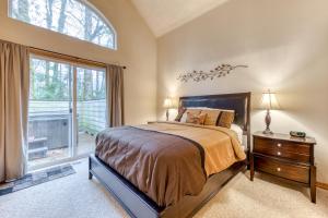 a bedroom with a bed and a large window at Clark's Mountain Condo in Welches
