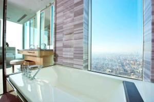 
a large bathroom with a large window at Osaka Marriott Miyako Hotel in Osaka
