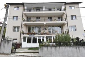 a large white building with a balcony at Vila Victoria in Râmnicu Vâlcea