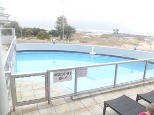 a swimming pool with a sign that reads residents only at Strand Beach Road Unit 416 in Strand