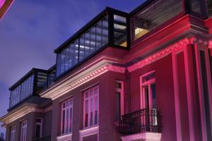 a red building with a balcony on top of it at The Central House Istanbul Taksim in Istanbul