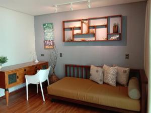 a bedroom with a bed and a desk and a chair at Boracay Beach Houses in Boracay