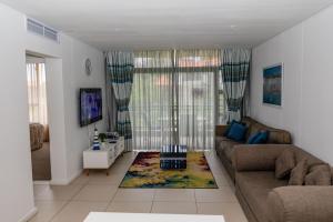 a living room with a couch and a table at Zimbali Suite 213 in Ballito