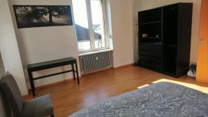 a room with a bedroom with a dresser and a window at RESTAURANT Hébergement "Relais de la Poste" in Masevaux