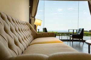 a couch in a room with a view of the ocean at Fu Yuan Tan Villa in Fuyuan