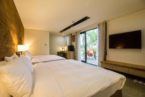 Postel nebo postele na pokoji v ubytování Fu Yuan Tan Villa