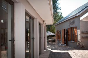 an empty alley between two buildings with a bike parked outside at Olden Rose Place in Lephalale +20 photos