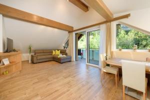 エーベン・イム・ポンガウにあるAppartement Mayrhofer - Ferienwohnungenのテーブルとソファのあるリビングルーム