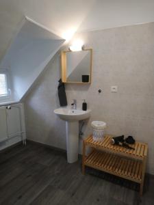 a bathroom with a sink and a mirror and a sink at Chambre du Relais in Masevaux