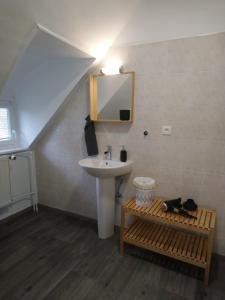 a bathroom with a sink and a mirror and a sink at RESTAURANT hébergement "Relais de la poste" in Masevaux