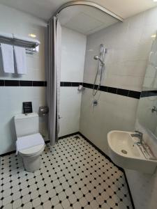 a bathroom with a toilet and a sink at Kimberley Hotel Georgetown in George Town