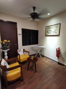 a living room with two chairs and a table at Kimberley Hotel Georgetown in George Town
