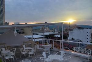 a balcony with tables and chairs on a building at Kimberley Hotel Georgetown in George Town
