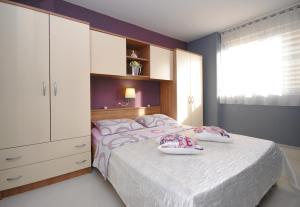 a bedroom with a large bed with shoes on it at Apartment Antea in Split