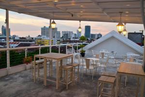 a rooftop patio with tables and chairs and a view of the city at Kimberley Hotel Georgetown in George Town