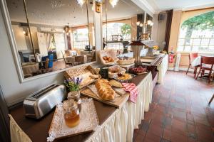 a bakery with a table with bread and pastries on it at Chenal Hotel in Beauvais