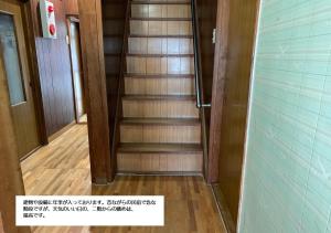 a hallway with a spiral staircase in a room at Minshuku Atsuhama in Sumoto