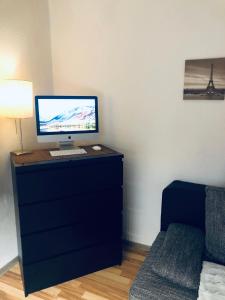 a computer sitting on top of a dresser in a room at Apartment Essen Holsterhausen in Essen