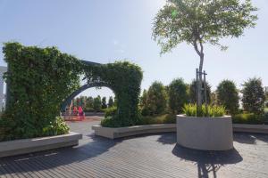 a garden with an arch and a tree in it at #FREE PICKUP# COACH RESIDENCES @ SUTERA AVENEU in Kota Kinabalu