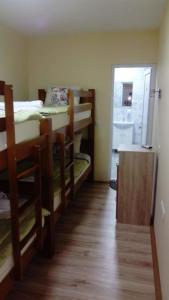 a room with several bunk beds and a hallway at Hostel „Ж" in Gradsko