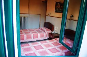 a room with two beds and a mirror at Diethnes in Larisa