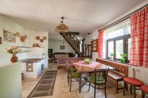 a kitchen and dining room with a table and chairs at Prázdninový dom Eliška*** in Rajecká Lesná
