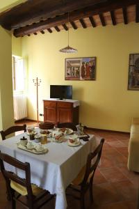 a dining room table with a white table cloth on it at Balcone sulle Meraviglie in Urbino