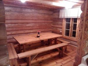 Hundi Holiday House في Kolodavitsa: ساونا خشبية مع طاولة في الوسط