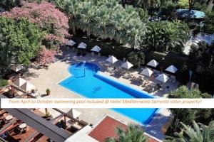 an overhead view of a swimming pool in a resort at M Suites Sorrento in Sorrento