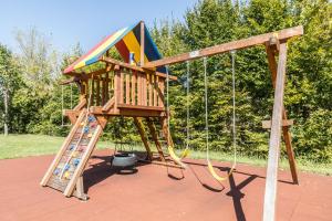 a wooden playground with a slide and a ladder at Atlantic Terme Natural Spa & Hotel in Abano Terme
