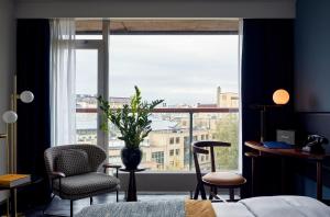 a bedroom with a large window with a view of a city at Park Centraal Amsterdam, part of Sircle Collection in Amsterdam