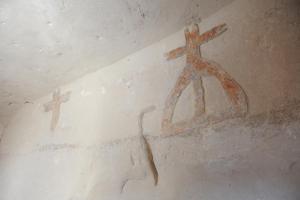 a room with two crosses on the wall at La Corte Dei Pastori in Matera