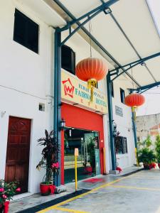 a fast food restaurant with orange lanterns hanging over it at Fairway Hotel in Malacca