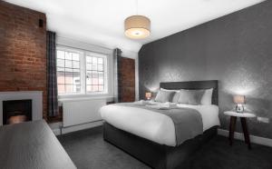 
a bedroom with a large bed and a large window at Qudos in Salisbury
