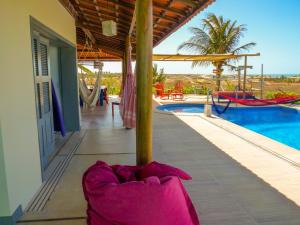 a person laying on the floor next to a swimming pool at Pousada Recanto Beija-Flor in Fortim