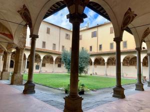 a view from the inside of a building with columns at Foresteria Sociale Florence Center by New Generation Hostel in Florence