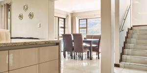 a kitchen and dining room with a table and chairs at 8 Sleeper Villa and 4 Sleeper Flatlet in Clarens