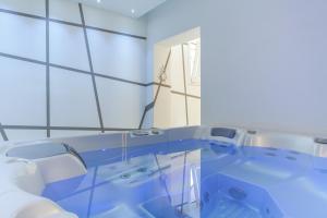 a bathroom with a blue tub in a room at Villa Capodarco B&B in Porto San Giorgio