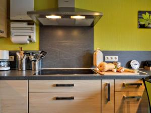 a kitchen with a sink and a stove at Alluring Holiday Home in Waimes with Garden in Waimes