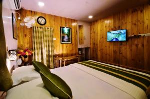 A bed or beds in a room at Ixzire Port Blair Resort