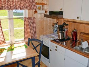a kitchen with a table and a stove and a counter top at Two-Bedroom Holiday home in Gravdal 2 in Gravdal